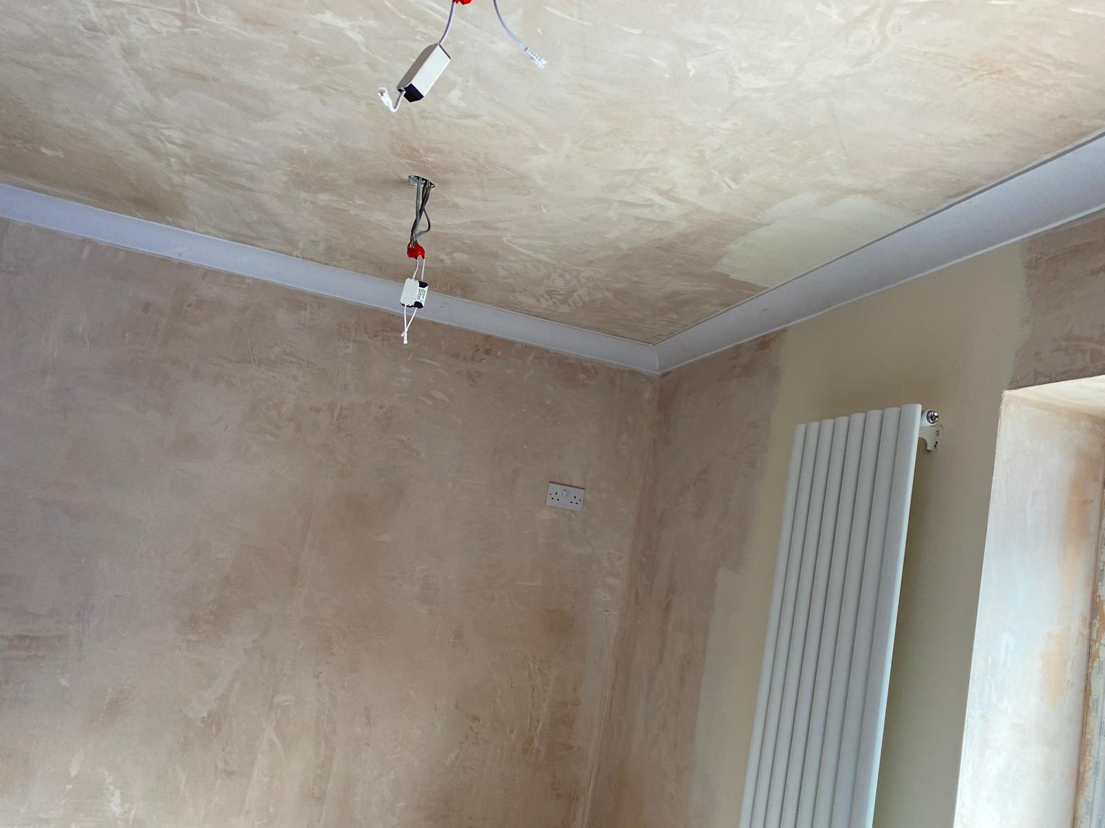 Freshly skim-plastered room with new designer radiator