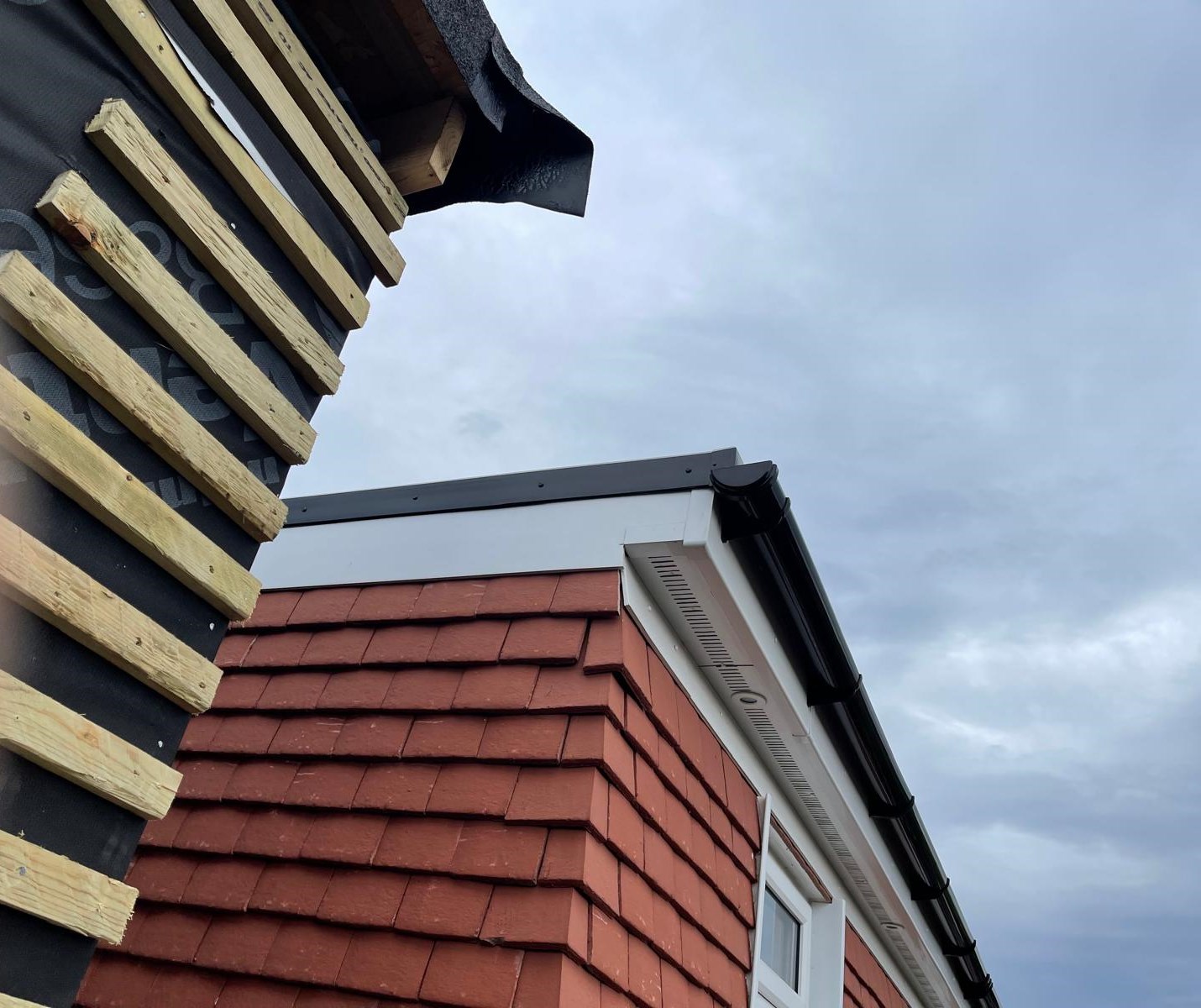 New tile-hung cladding with black fascias, soffits and guttering