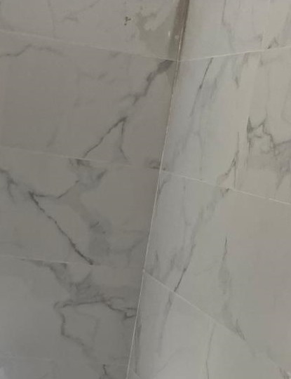 Tiling — marble-effect porcelain bathroom wall tiling by Yorkshire Built Group